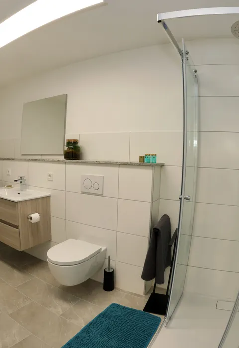 Bathroom with washing machine, dryer and rain shower