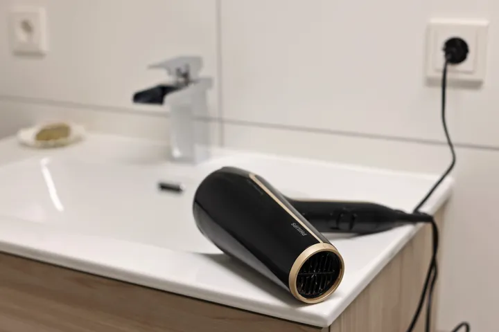 Hairdryer at the bathroom washbasin