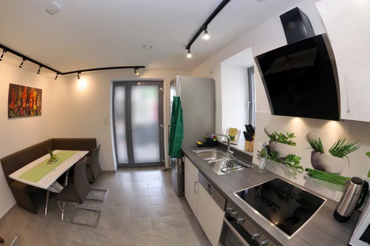 Kitchen counter with dining area and view towards the terrace door