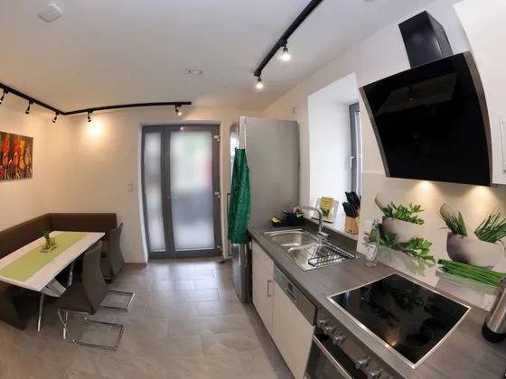 Kitchen counter with dining area and view towards the terrace door