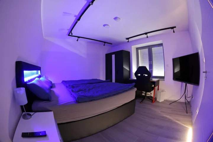 Bedroom with atmospheric LED bed lighting